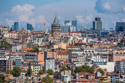 Cityscape against cloudy sky