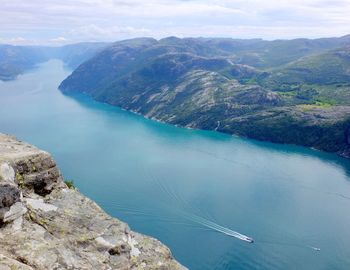 High angle view of lake and mountains against sky