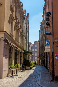 Street amidst buildings against sky in city