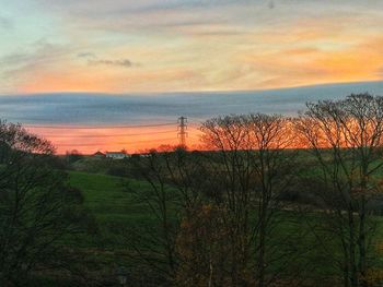 Scenic view of field against sky during sunset