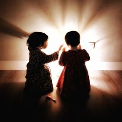 Siblings standing in corridor