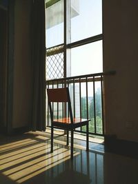 Chair in empty room by window
