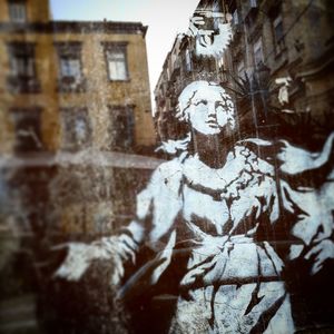 Close-up of woman and buildings during winter