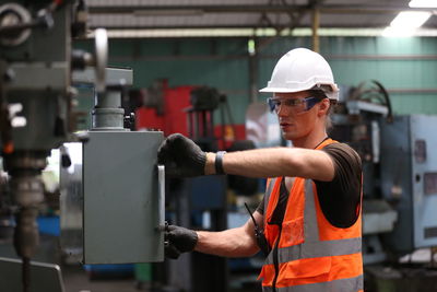 Rear view of man working in factory