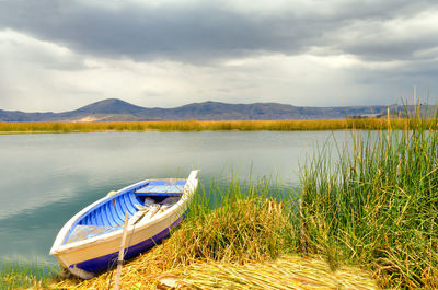 Boat moored in lake titicaca against sky