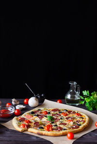 High angle view of pizza on table against black background