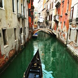 High angle view of canal amidst buildings