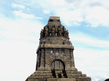 Low angle view of historical building against cloudy sky