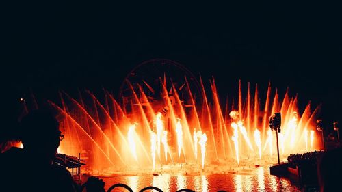 Firework display against clear sky at night