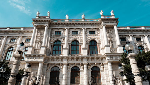 A baroque style building facade with contrast daylight sunshine and clear skies, vienna, austria.