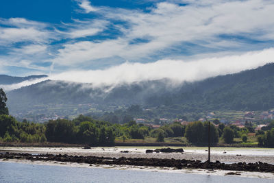 A sea of white clouds going down the mountains to the village of noia in galicia, spain