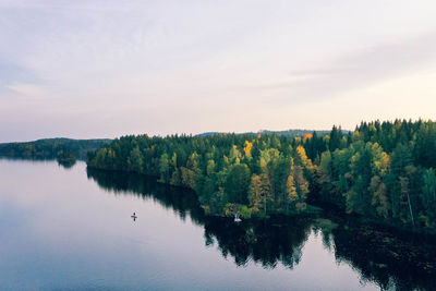 Scenic view of lake in forest against sky