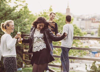 Female friends dancing during party on roof garden