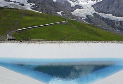 High angle view of reservoir against mountains during winter