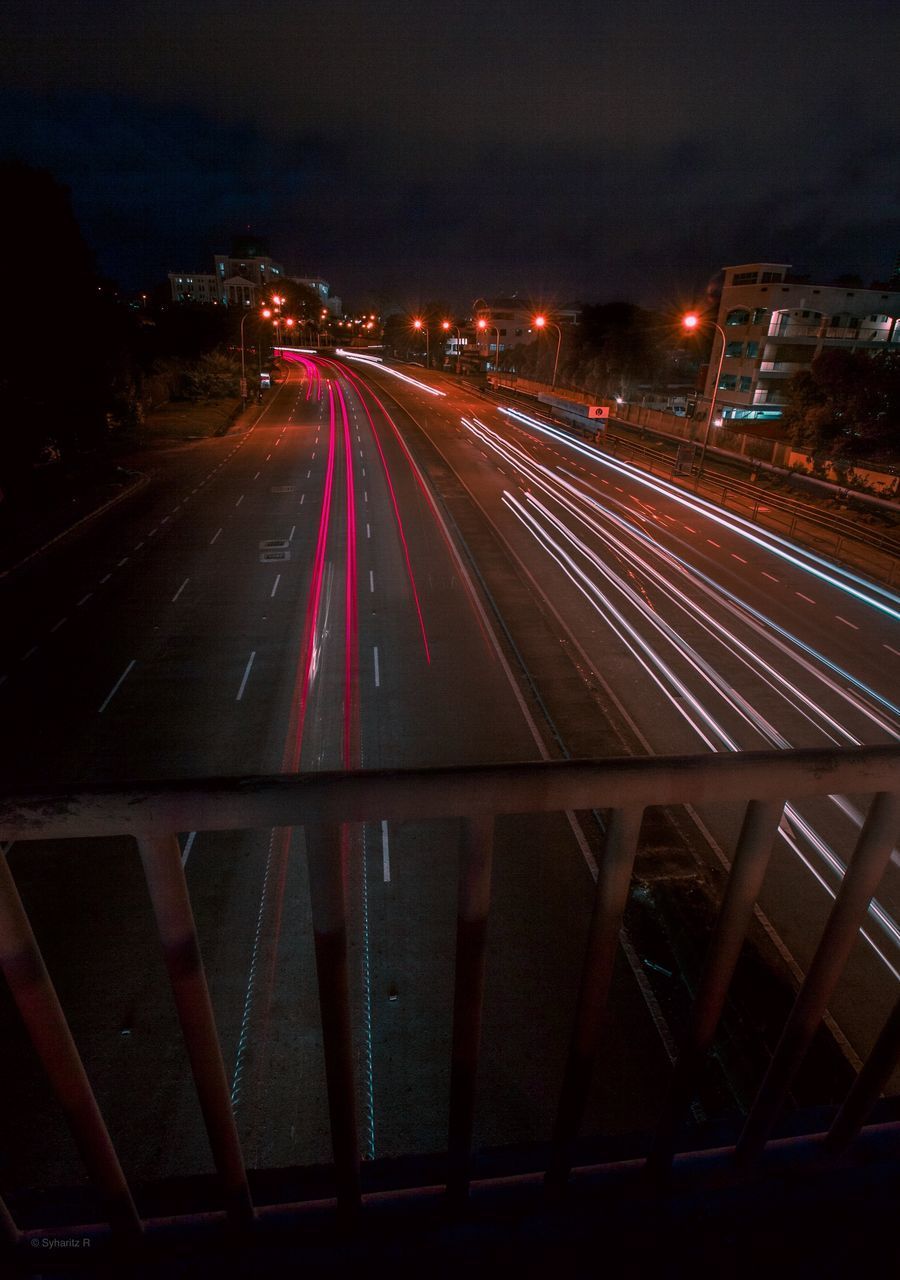 HIGH ANGLE VIEW OF LIGHT TRAILS ON ROAD