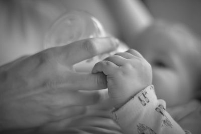 Cropped hand feeding baby