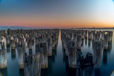 Panoramic view of wooden posts in sea against clear sky