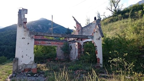 Built structure on mountain against sky