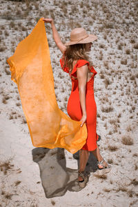 Woman wearing hat while standing on beach