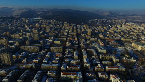 Aerial view of illuminated cityscape against sky