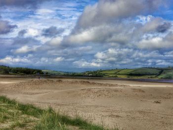 Scenic view of landscape against cloudy sky