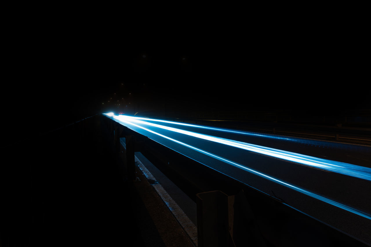 LIGHT TRAILS ON ILLUMINATED BRIDGE