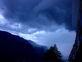 Scenic view of silhouette mountains against sky at dusk