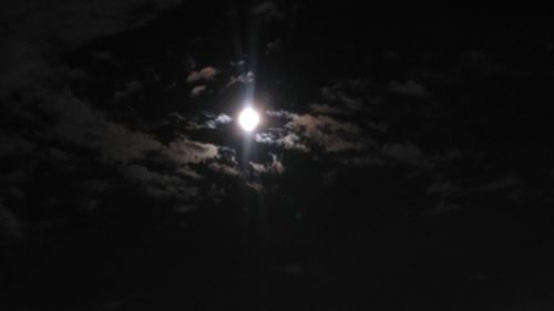 Low angle view of moon in sky at night