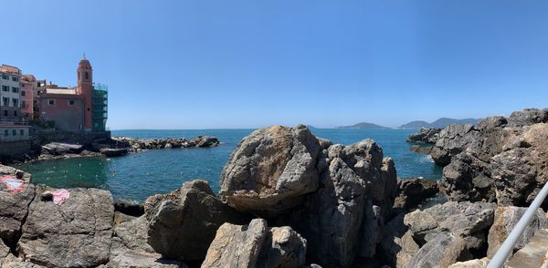 Panoramic view of sea and buildings against sky