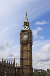 Low angle view of clock tower against sky in city