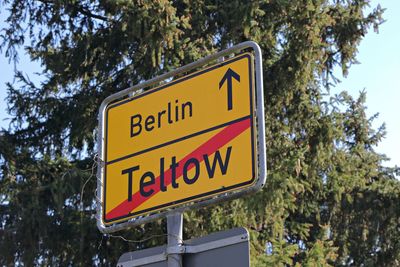 Low angle view of road sign against trees