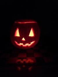 Close-up of illuminated pumpkin against black background