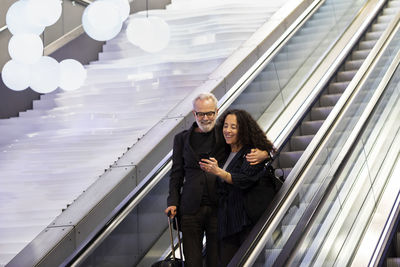 Mature couple on escalator