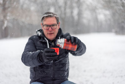 Portrait of man holding camera