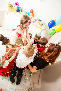 High angle view of kids with balloons