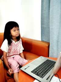 Young woman using laptop at home