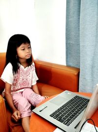 Young woman using laptop at home