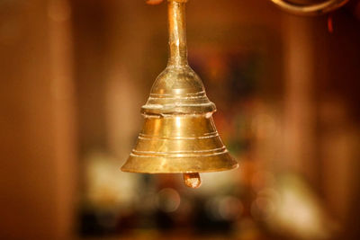 Close-up of bell hanging against blurred background
