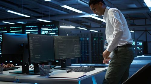 Rear view of man working in office