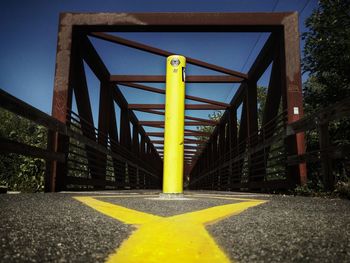 Yellow metallic structure against sky