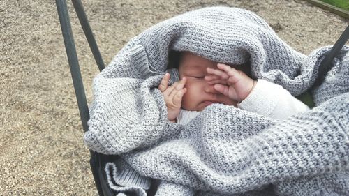 Baby wearing warm clothing in carriage