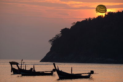 Silhouette boat on beach against sky during sunset