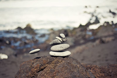Stacked stones on rock at beach