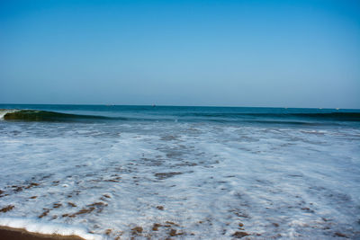 Scenic view of sea against clear blue sky