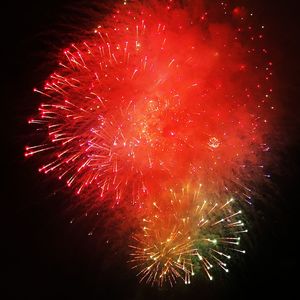 Low angle view of firework display at night