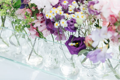 Close-up of flowers in vases on table