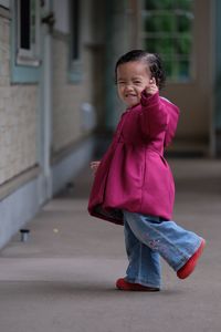 Portrait of girl standing in corridor