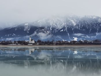 Scenic view of lake against sky during foggy weather