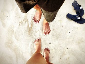 Low section of person on sand at beach