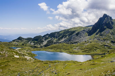 Scenic view of lake and mountains against sky